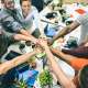 Young employee startup workers group stacking hands at urban stu